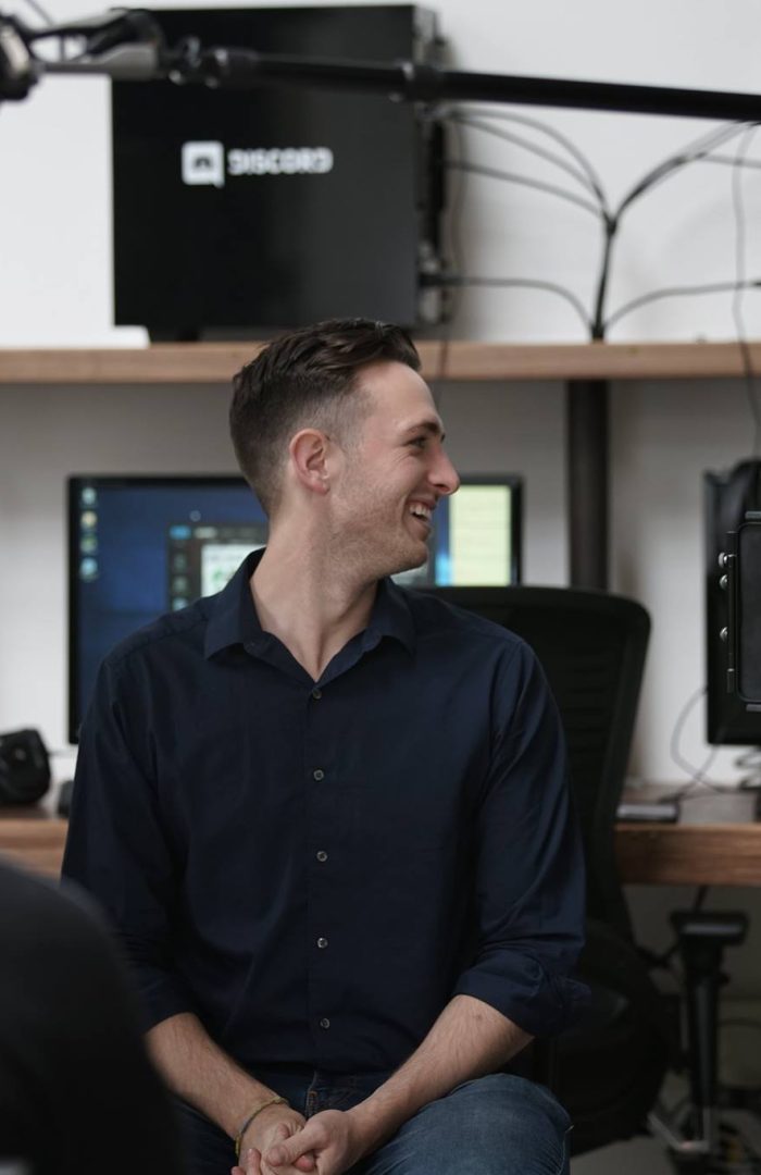 A guy smiling in the studio before production