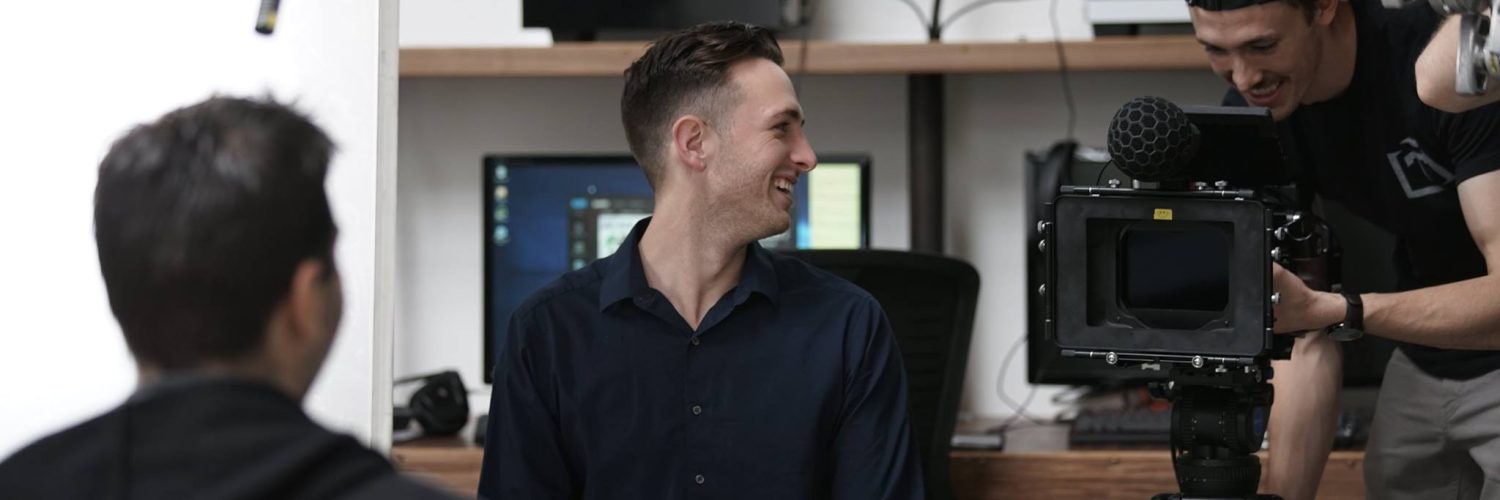 A guy smiling in the studio before production